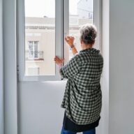 Woman closing window