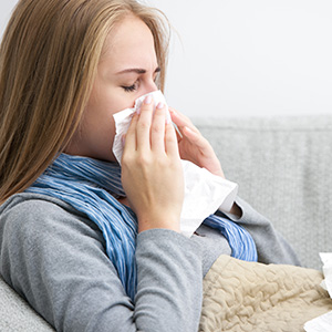 Woman blowing her nose