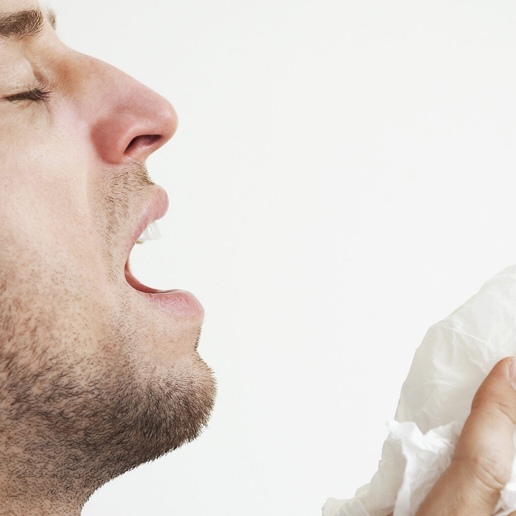 Image of a man about mid sneeze