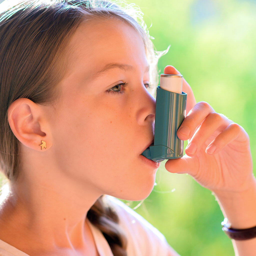 Image of a young girl using an inhaler