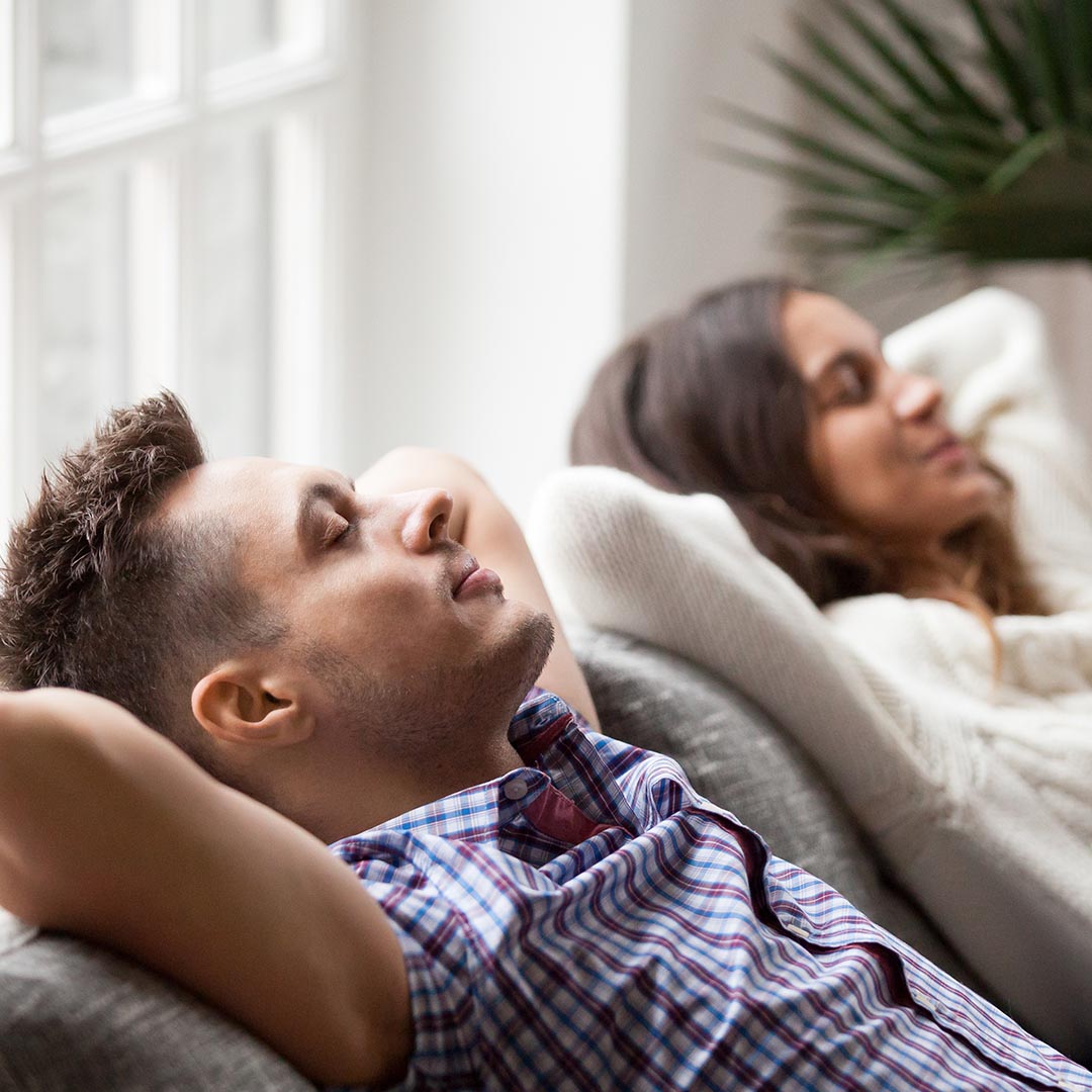 Man and woman relaxing on the couch