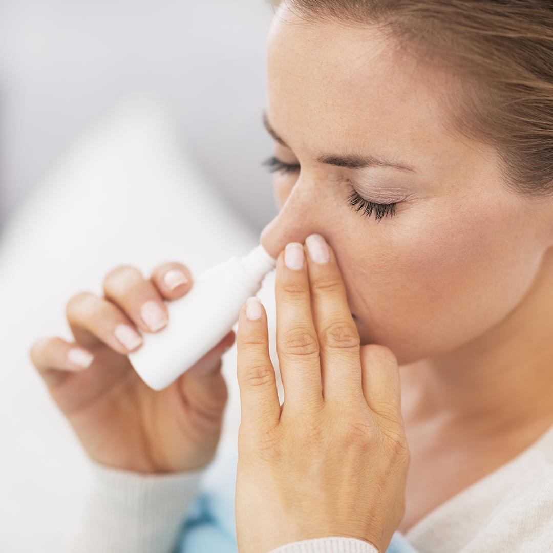 Woman using a nasal allergy medicine