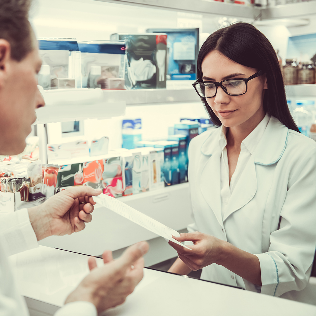 Man grabbing a prescription from the pharmacist