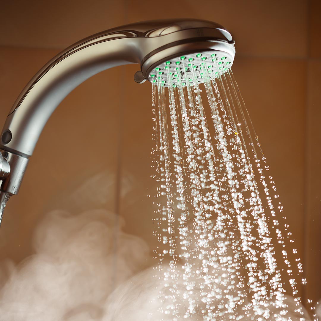 Water coming from shower head and steam