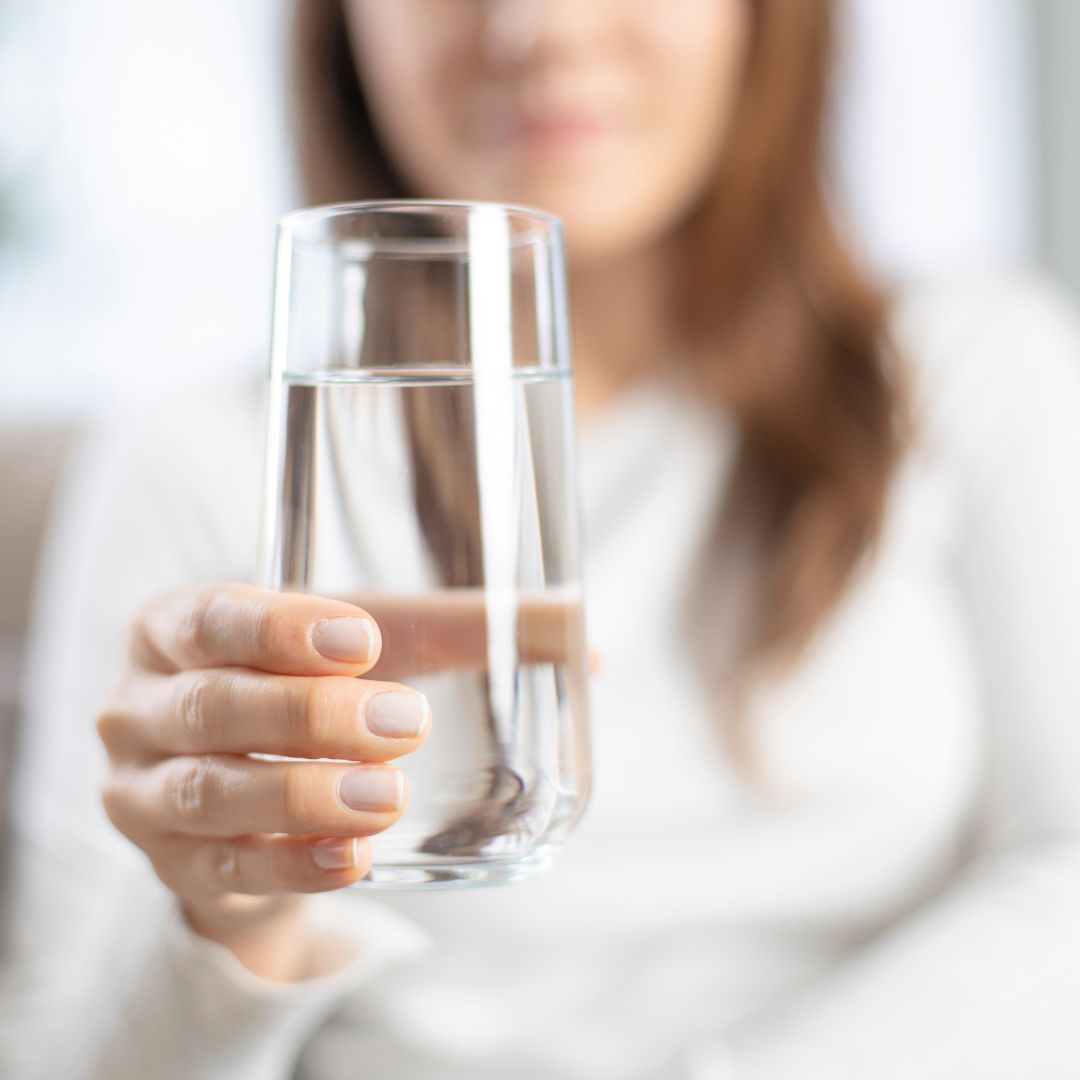 Someone holding glass of water