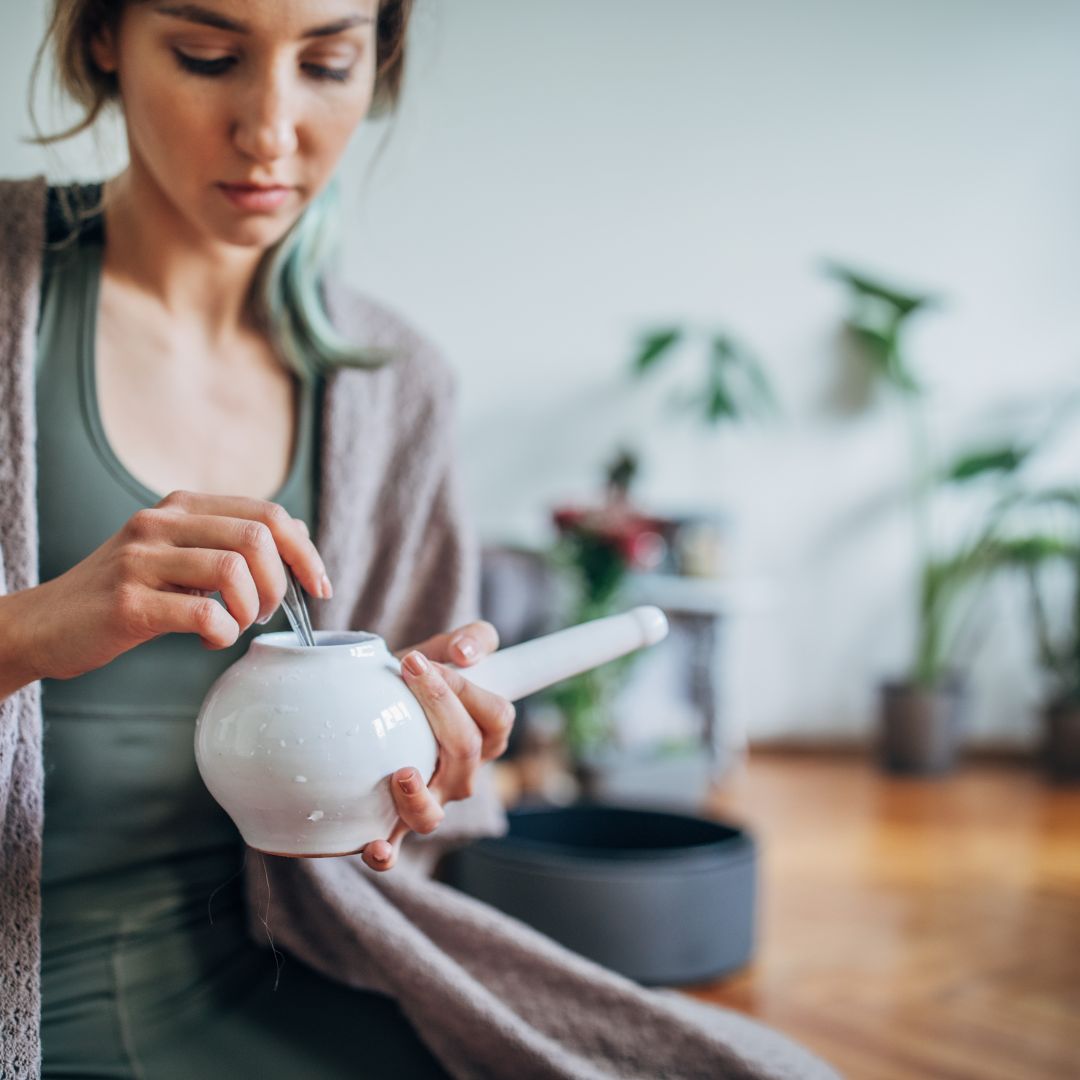 Woman filling neti pot