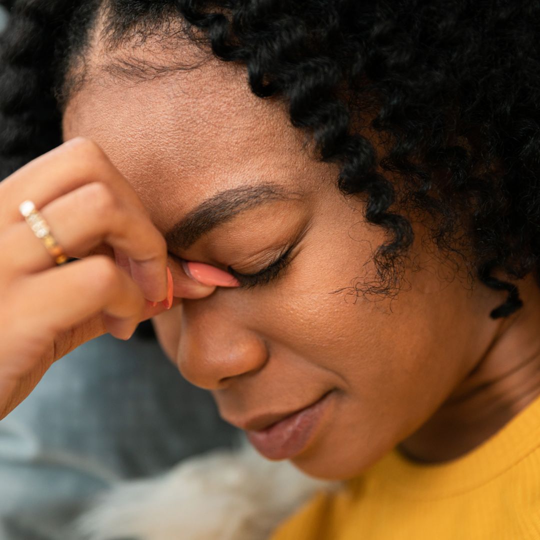 Woman holding nose