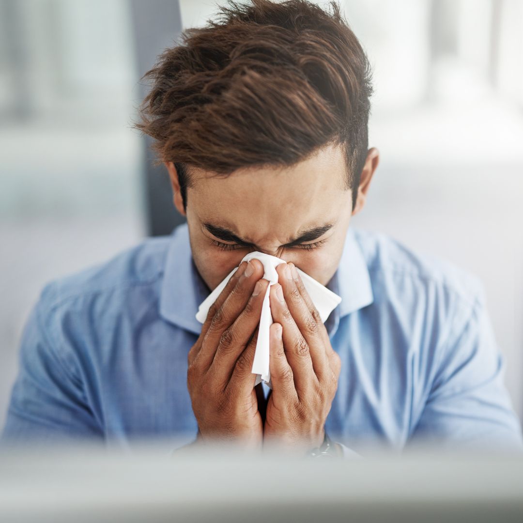 man blowing nose