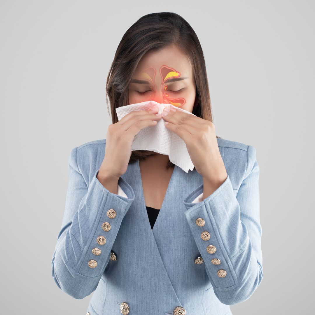 woman blowing nose with sinuses highlighted