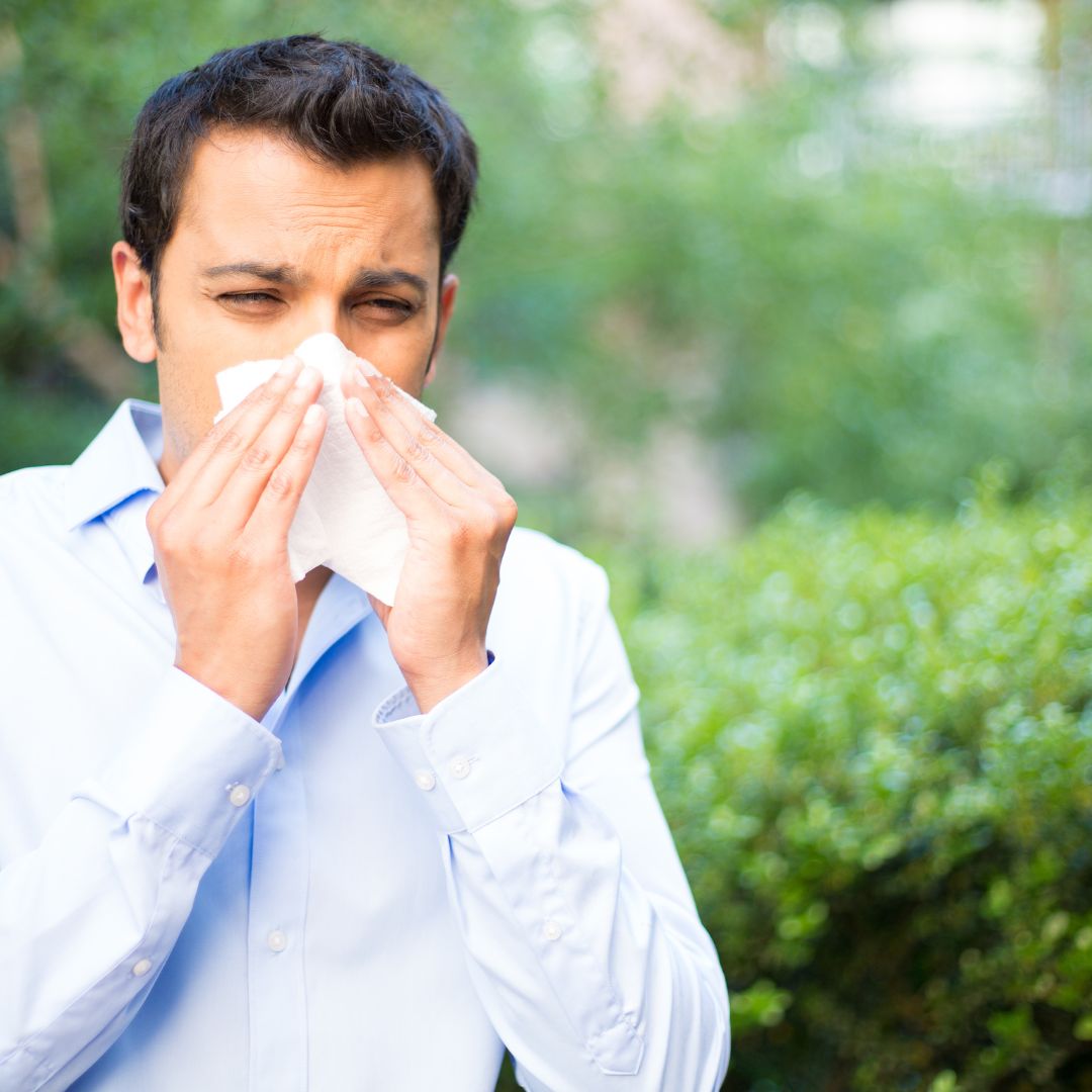 man blowing his nose