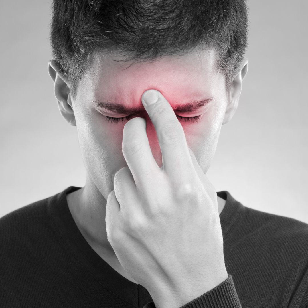 man holding nose